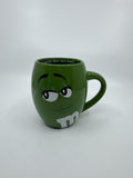 M&M World I Melt for No One Large 20oz Green Barrel Coffee Mug Cup (Chip/Crack)