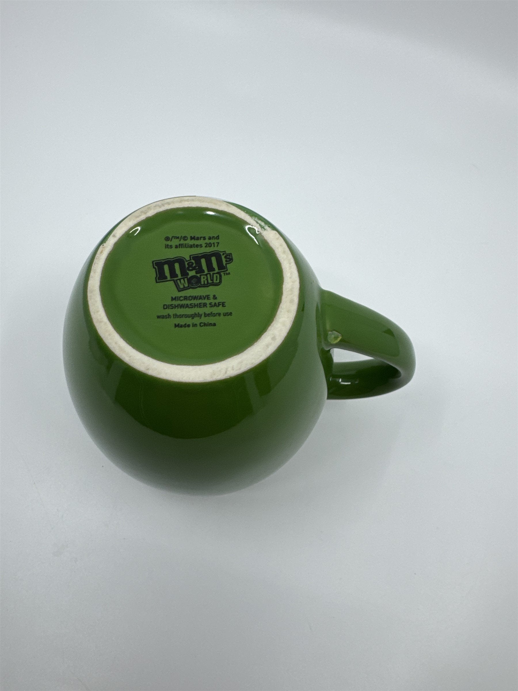 M&M World I Melt for No One Large 20oz Green Barrel Coffee Mug Cup (Chip/Crack)