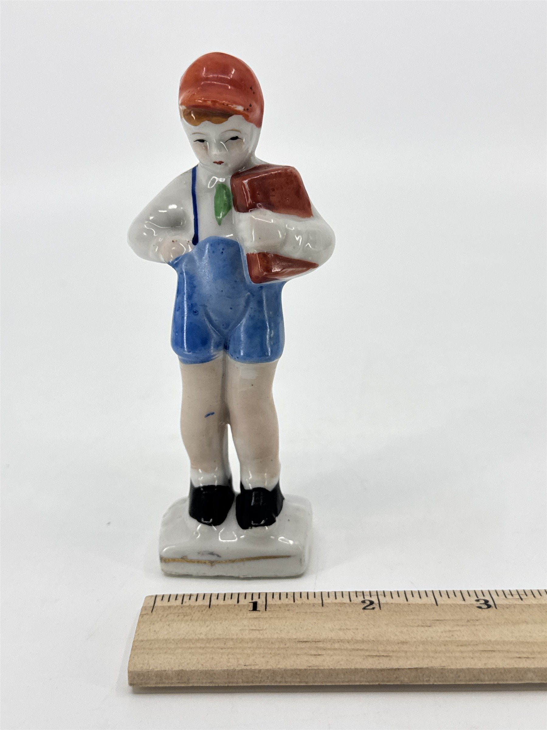 Vintage Porcelain Figurine Small Boy W/ Blue Trousers And A Brown Book Japan